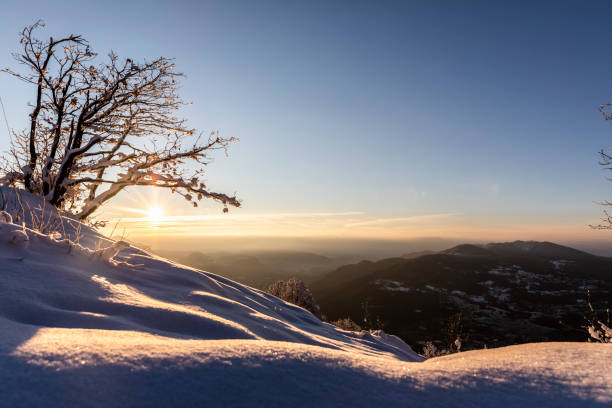 istock Sunrise over snowy hill 1298535907