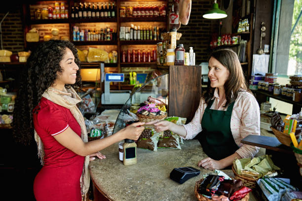 istock Young Female Customer Paying for Purchase in Specialty Store 1298539454