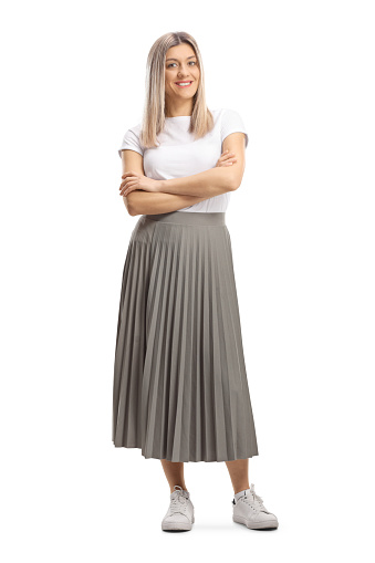Full length portrait of a young blond woman in a pleated skirt isolated on white background