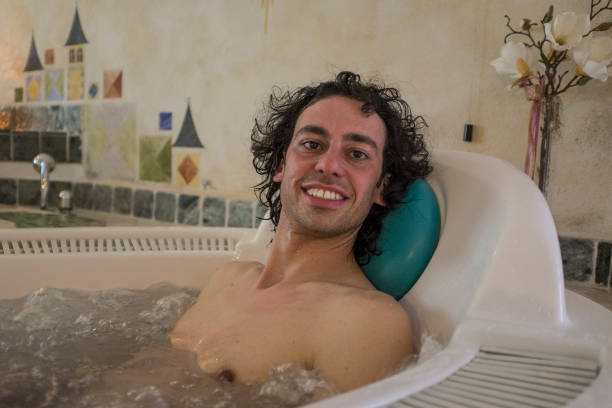 istock young man in a hot tub 1298542611