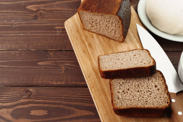 istock Sliced rye bread on brown wooden background 1298543032