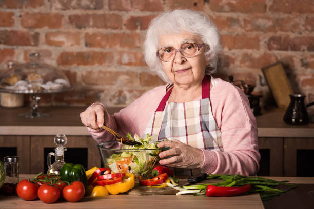 istock Senior woman cooking 1298546808