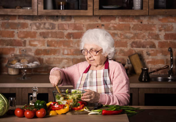 istock Senior woman cooking 1298546817