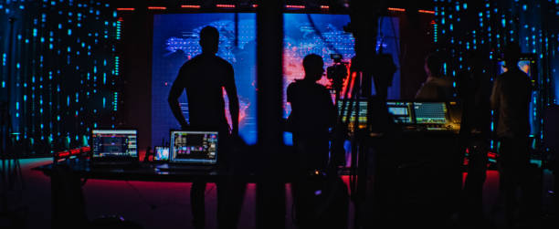 istock Movie set in silhouettes. Large screen with projection in background 1298550009