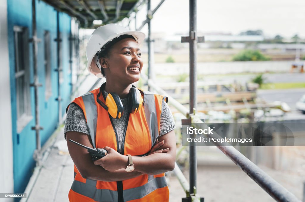 Putting in the dedication to build her dreams Shot of a young woman working at a construction site Occupation Stock Photo