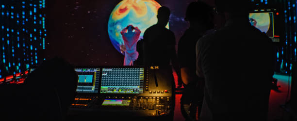 istock Movie set in silhouettes. Large screen with projection in background 1298550051