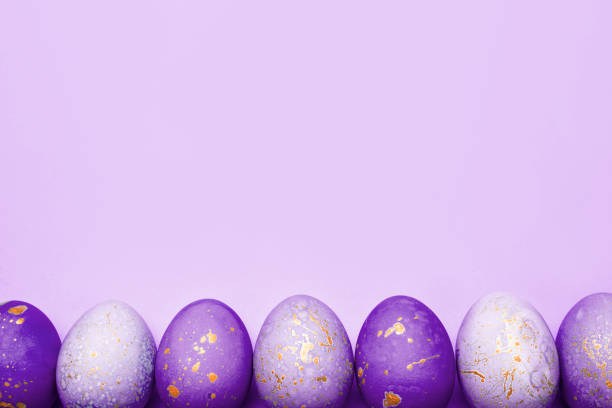 istock Easter frame of eggs painted in purple color. 1298552971
