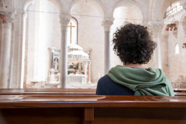 a faithful in San Nicola church in Bari stock photo