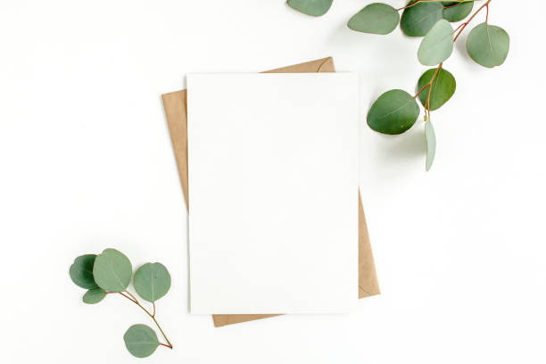 istock Mockup invitation, blank greeting card and green leaves eucalyptus. Flat lay, top view 1298554617