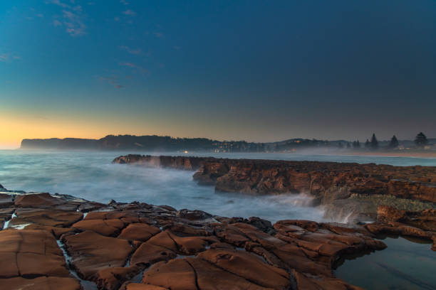 Early Morning Seascape from Rock Platform Dawn seascape from tessellated rock platform at North Avoca Beach on the Central Coast, NSW, Australia. avoca beach photos stock pictures, royalty-free photos & images