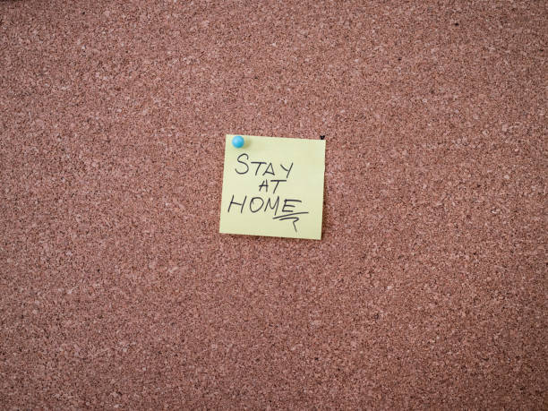 istock Adhesive note with covid 19 text pinned on a bulletin board 1298558680