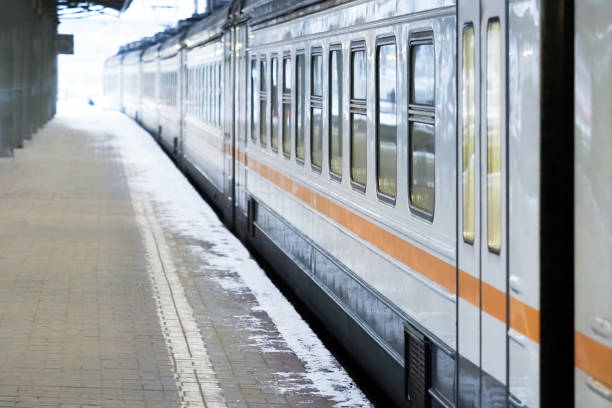 istock Passenger railway wagon on the platform in winter. Railroad station 1298562248