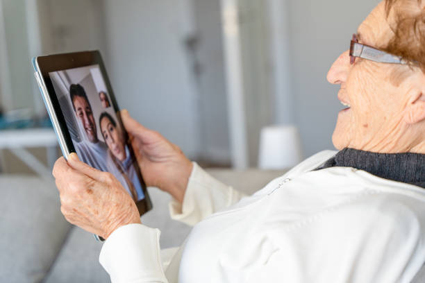 istock Content aged woman talking on video chat on tablet 1298562388