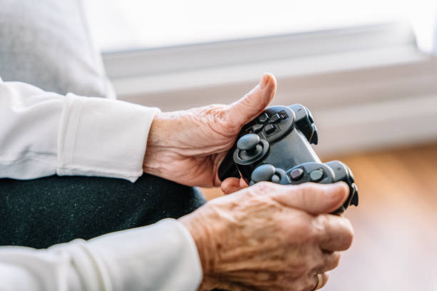 istock Crop senior woman with gamepad at home 1298562964