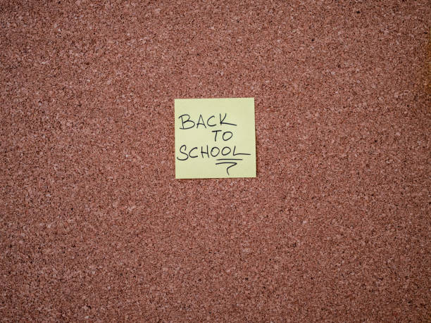 istock Adhesive note with back to school text on a bulletin board 1298563124