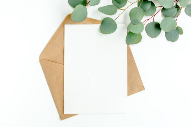 istock Mockup invitation, blank greeting card and green leaves eucalyptus. Flat lay, top view 1298563752