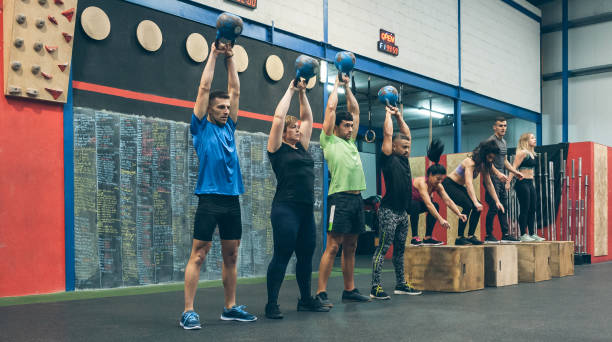 istock Athletes exercising with kettlebells and doing box jumps 1298565263