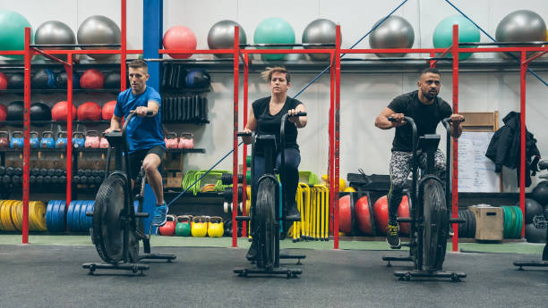 istock Athletes doing air bike indoor 1298565265