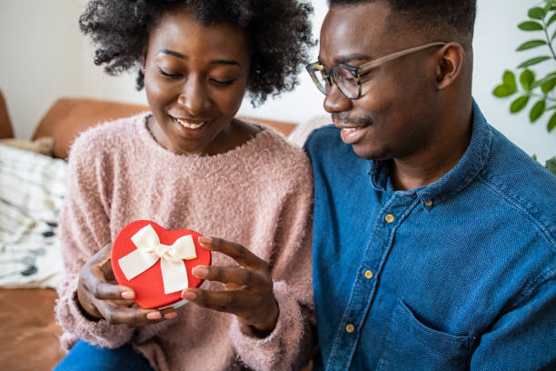 istock Romantic man giving a love present to his girlfriend 1298567722