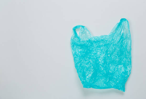 istock Clear blue disposable plastic bag on gray background. Space for text 1298568752