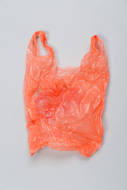 istock Clear red disposable plastic bag on gray background. Space for text 1298568779
