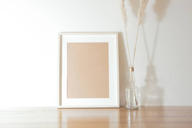 istock Simple interior decoration and photo frame object layout. Tabletop plants, pampas grass, chrysanthemums. 1298569863