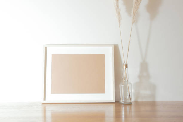 istock Simple interior decoration and photo frame object layout. Tabletop plants, pampas grass, chrysanthemums. 1298569881