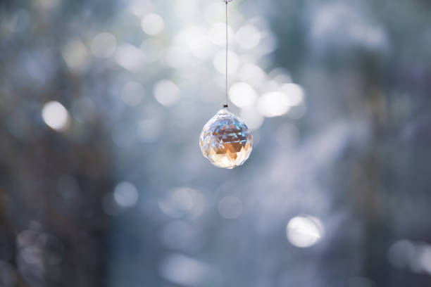 istock Windowside with beautiful glass crystal suncatcher decoration 1298570131