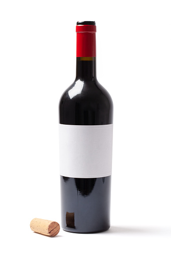 Open red wine bottle with a blank white label and cork