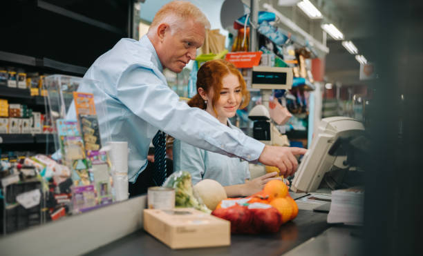 istock Grocery store manager training a new employee 1298570518
