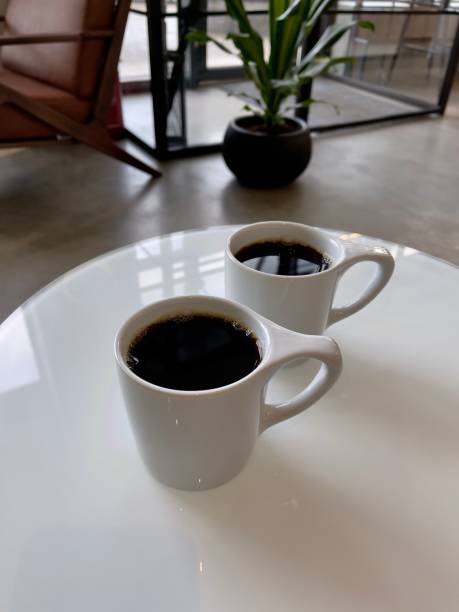 istock two white cups of black coffee 1298570643