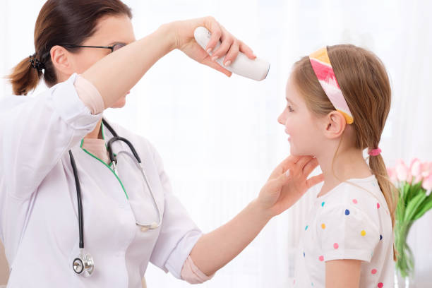 istock Doctor checking girls temperature 1298571054