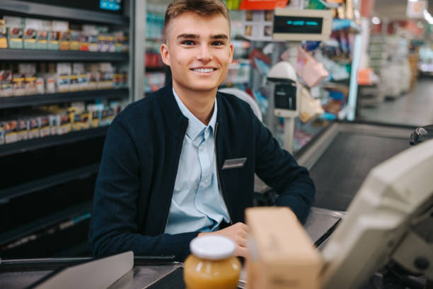 istock Cashier at supermarket checkout 1298571919