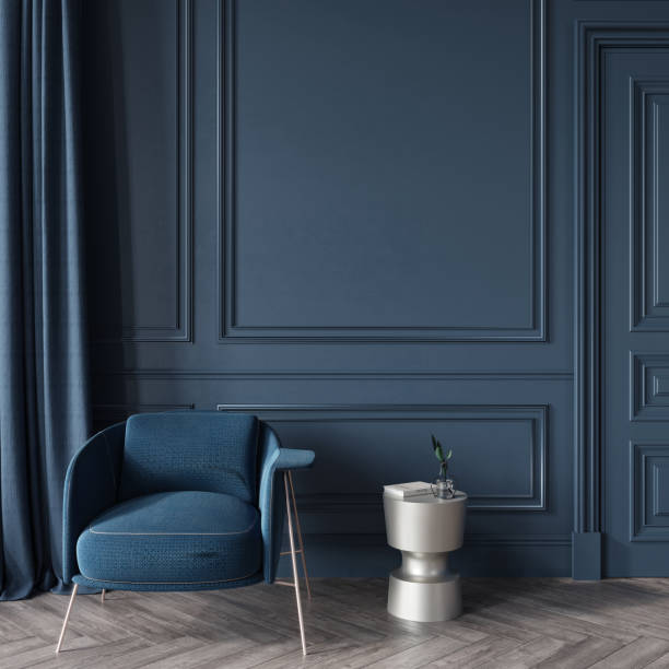 istock Interior in dark blue with an upholstered armchair and a metal table 1298574819