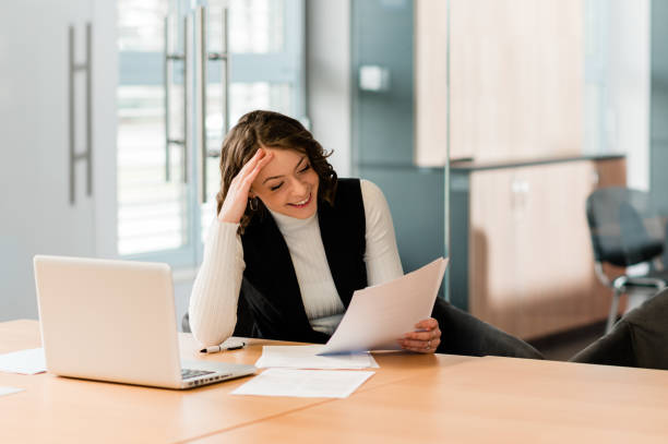 istock Woman working in the office and smiling. 1298575513