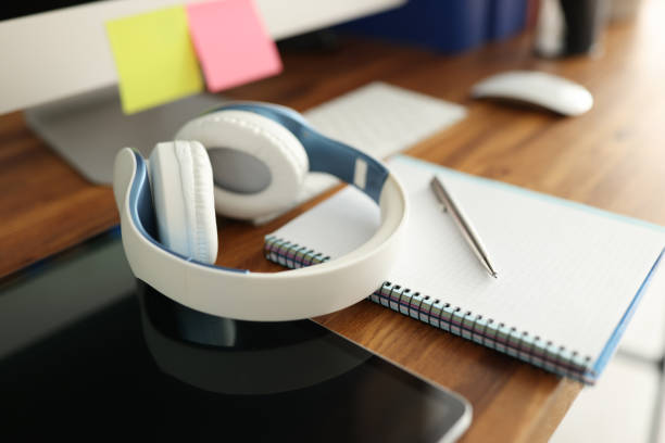 On table are headphones tablet and diary with pen. Remote learning and training concept