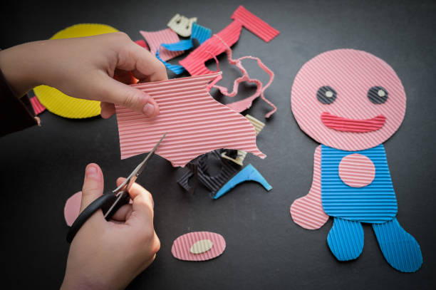 istock Child cutting colored paper. 1298589160