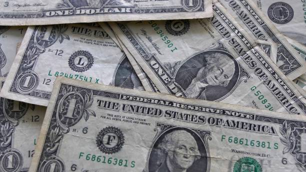 istock Dollar Bills Cash on a Table Close Up 1298601963