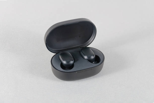 istock Media headphones in charger on gray isolate background 1298603965