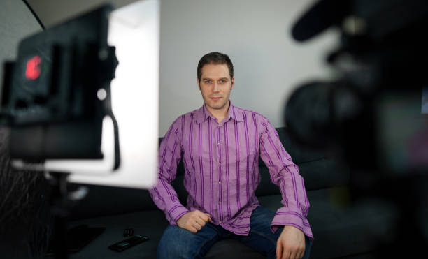 istock Man is ready to record videoblog at home. 1298605763