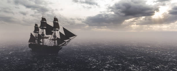 istock Pirate ship sailing on the ocean. Stormy clouds 1298606248