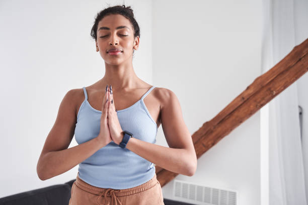 istock Girl keeping hands in namaste gesture while practicing yoga 1298606291