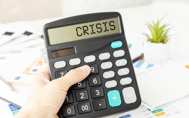 istock A calculator with the inscription CRISIS is placed in the stack of documents. Business concept 1298607015