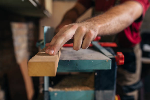istock Anonymous Carpenter Working on a Piece of Furniture in his Workshop 1298607080