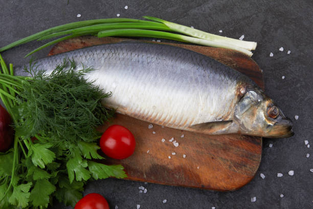 istock Herring fish on wooden board 1298607918