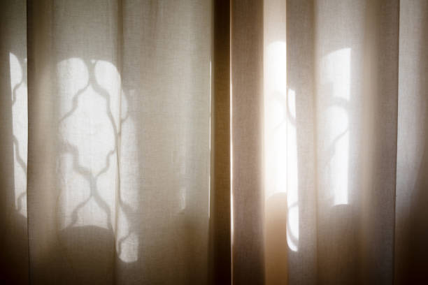 istock Reflection of a window on a beige curtain 1298607960