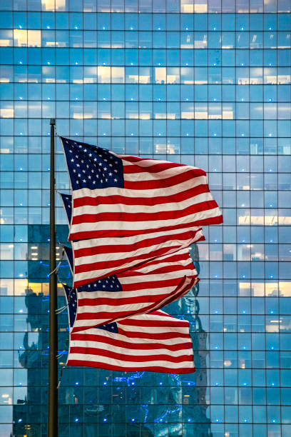 istock US Flags flying in Philadelphia PA with illuminated office tower background 1298609465