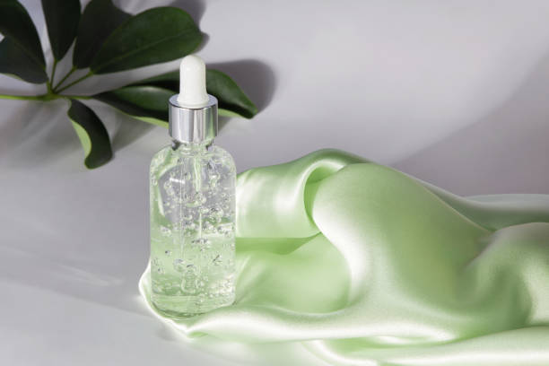 istock Anti aging serum in a glass bottle on a gray background 1298609807