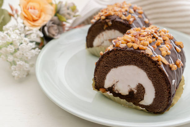 istock Chocolate swiss roll cake on plate 1298610111