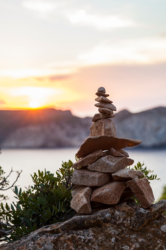 Cairn as a prominent signpost for orientation during relaxed hiking on the Spanish island of Mallorca